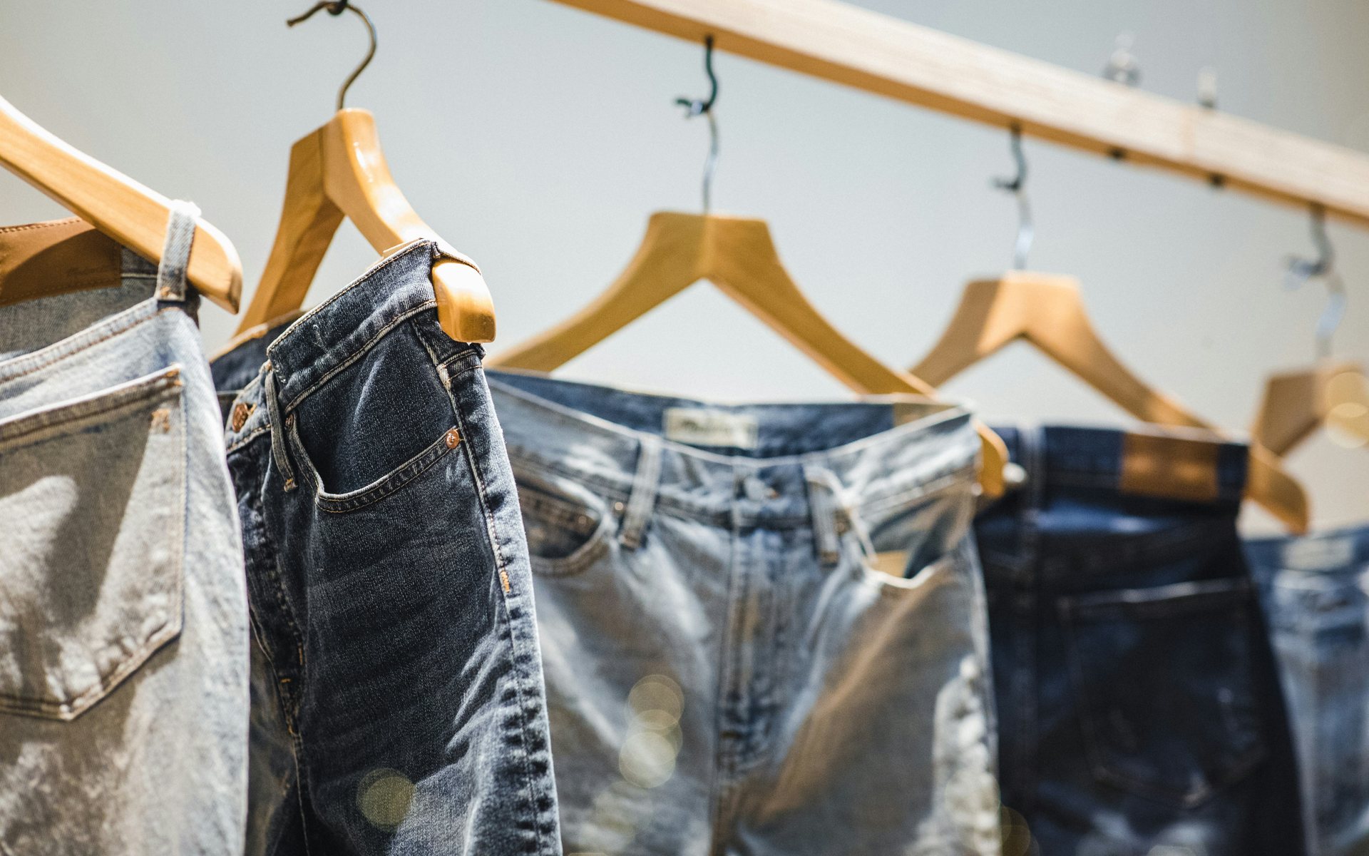 Assorted denim washes hanging on a rail